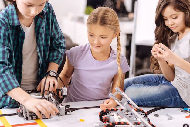 Photo: Students cheering as their robot finally works after multiple retries