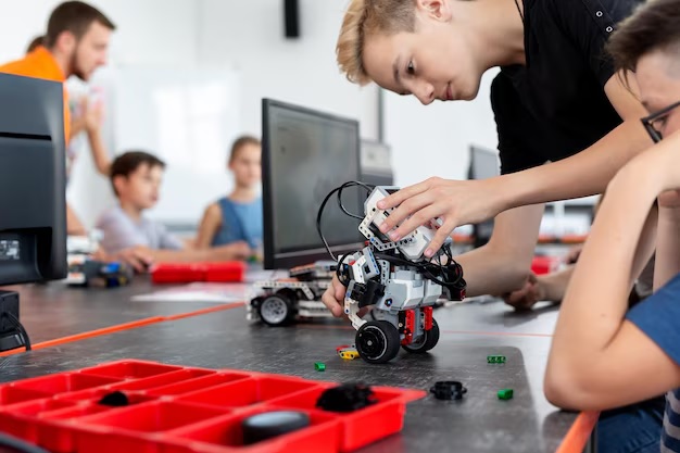 Photo: Student connecting sensors and motors on a robot build
