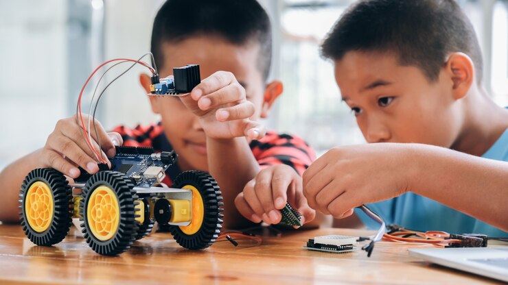 Photo: Students assembling a wheeled robot with sensors