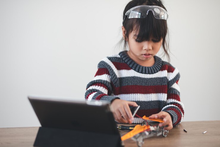 Header image: Child building a balloon-powered car at home with simple materials