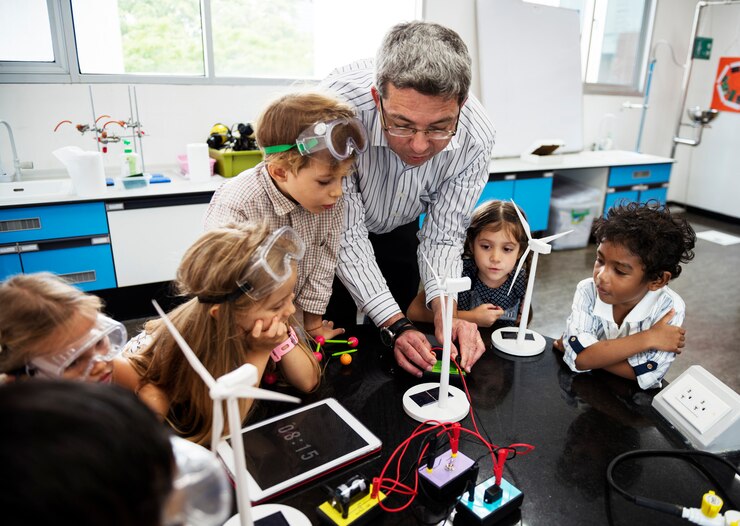 Header image: Teacher helping students with STEM activity